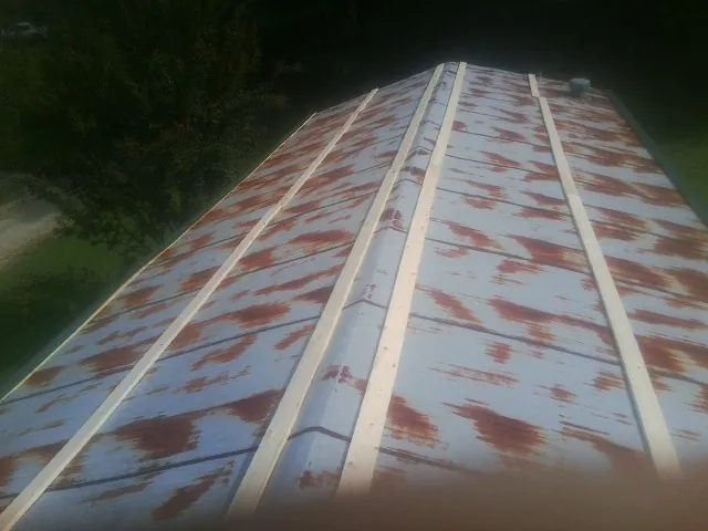 Rusted metal roof panels with new wood purlins before replacement — Storm Damage Roof Repair in Northbridge by Roofing Brothers