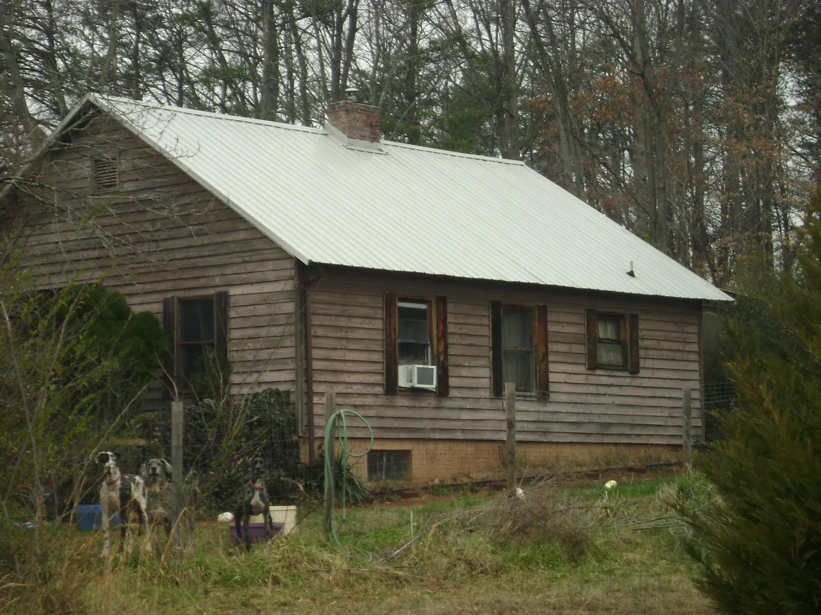 White metal roof on an old wood sided farmhouse, from a Metal Roof Installation job in Northbridge